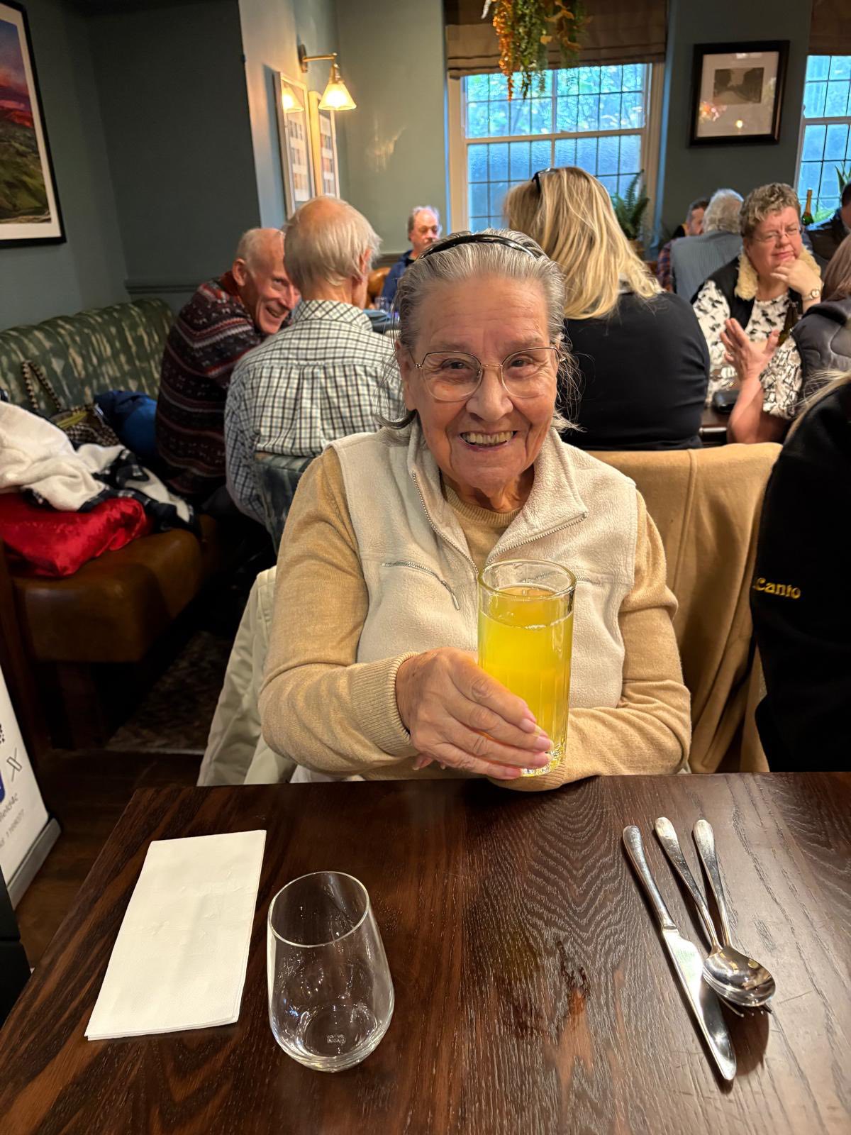 Twelve Trees care home residents enjoying drinks and conversation during pub outing