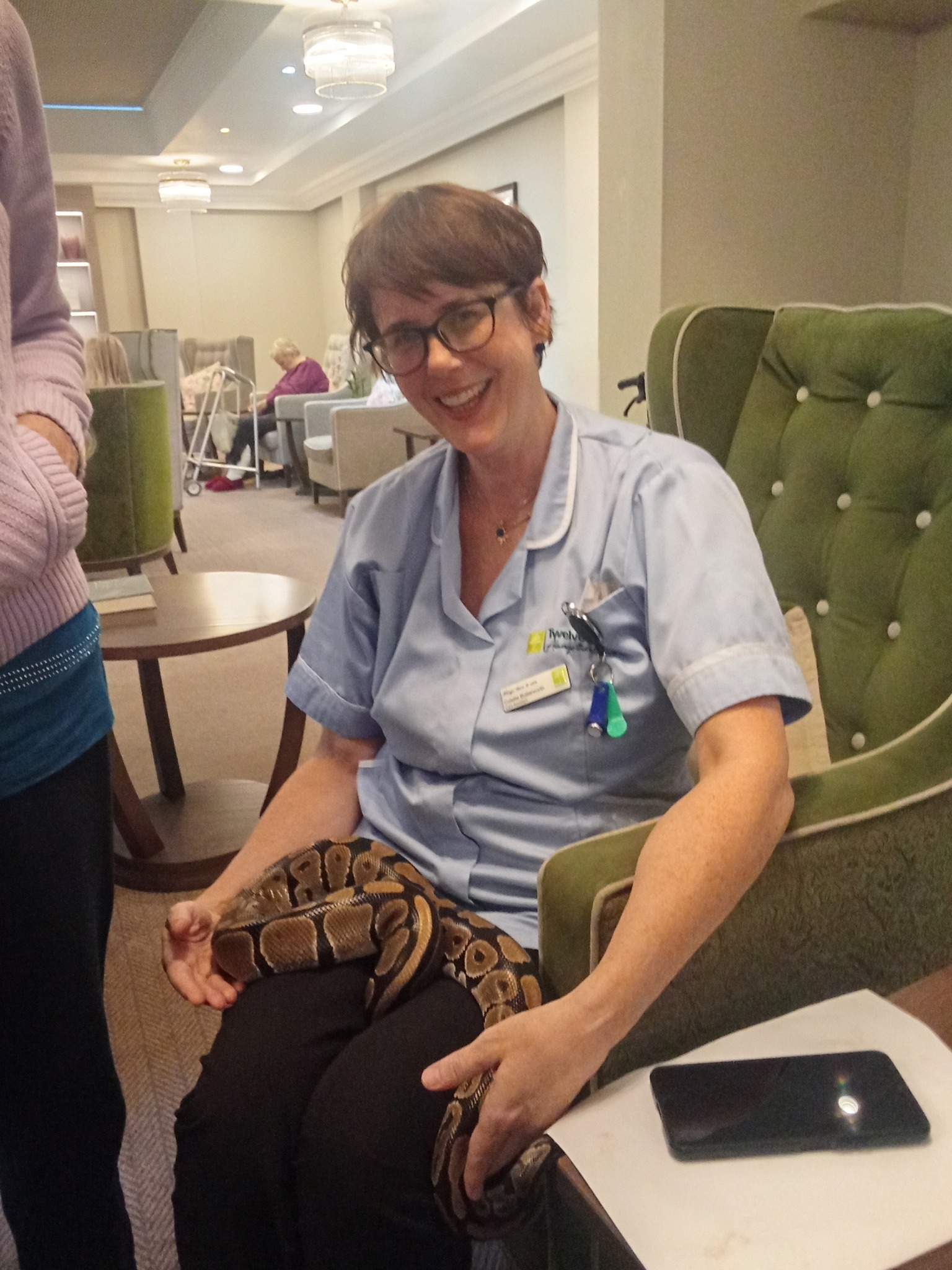 Snake handler introducing reptiles to Meadowbrook care home residents