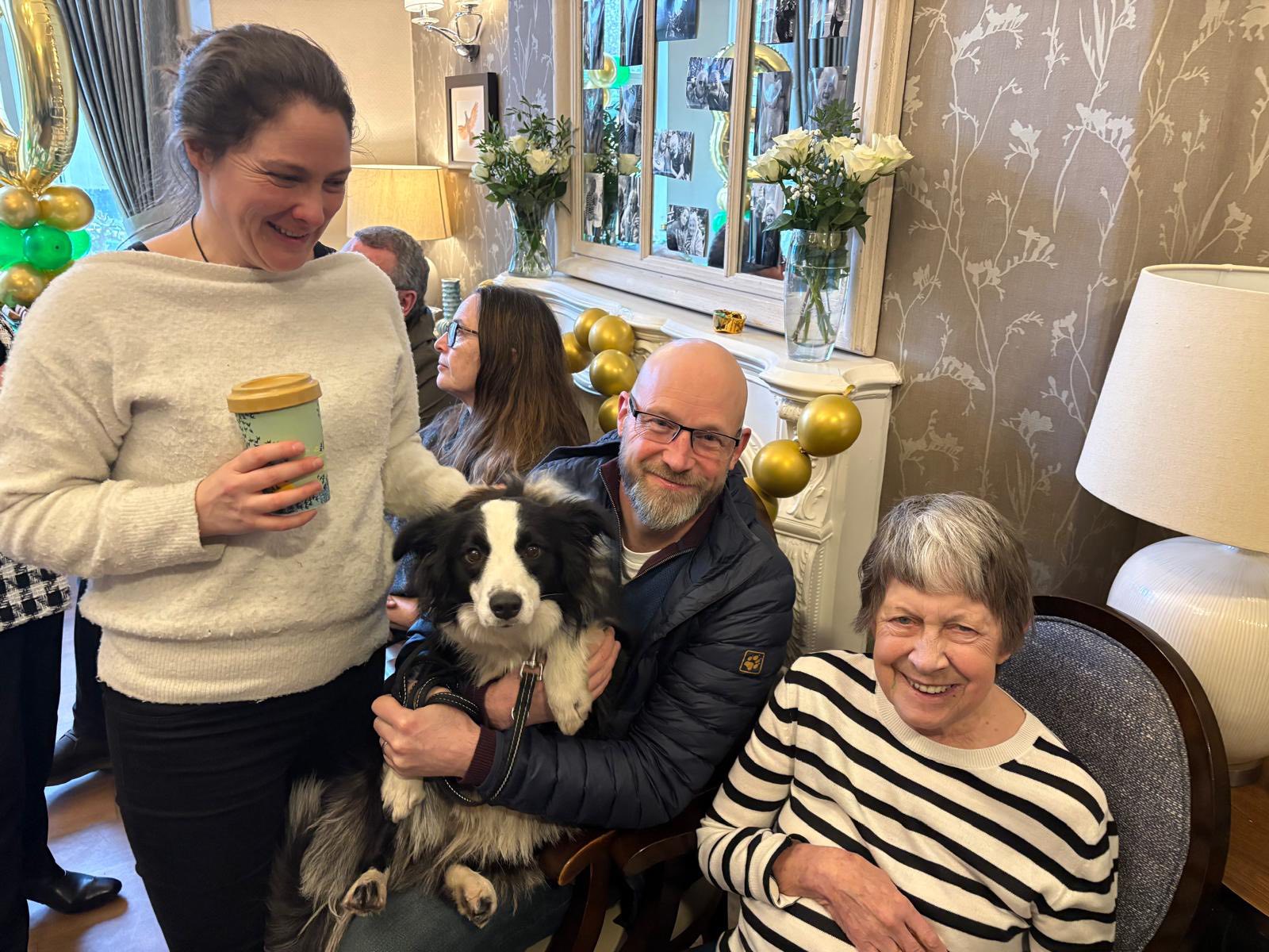 Family members and a beloved pet enjoying the 30th anniversary celebrations at Twelve Trees Care