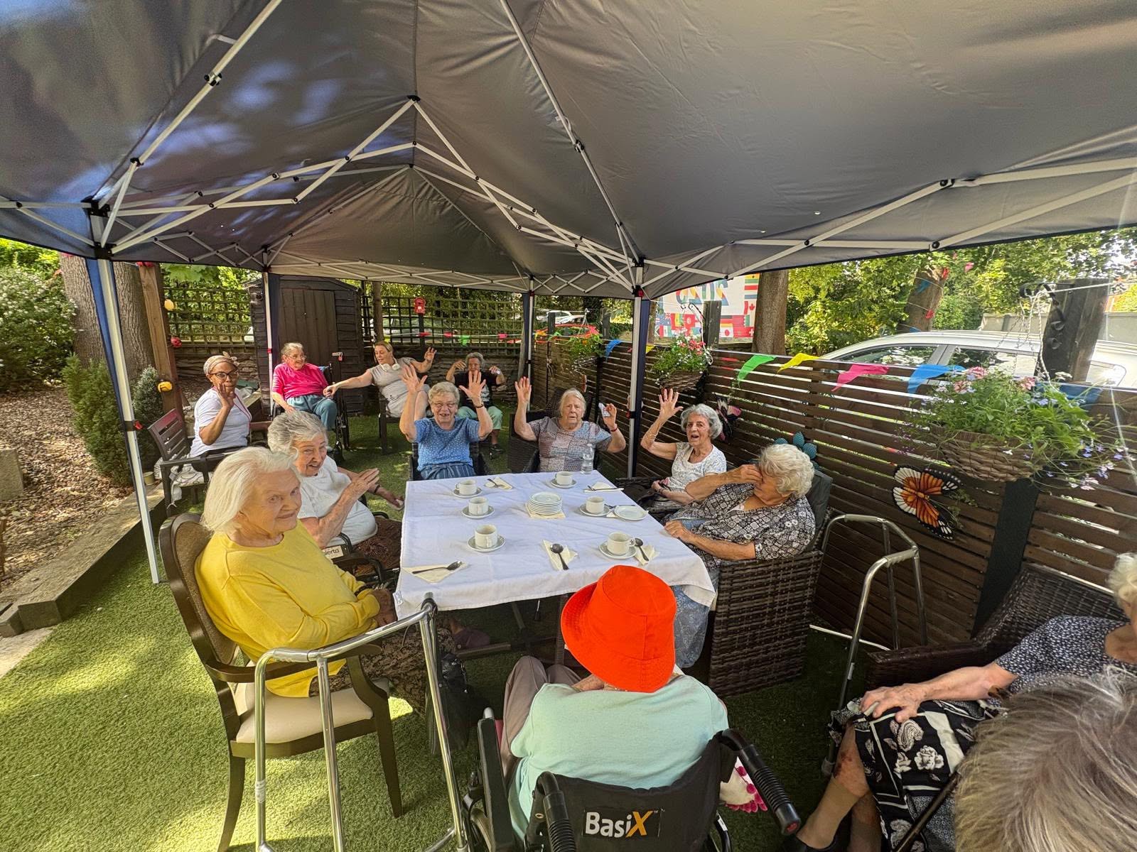 Residents at Twelve Trees Sheffield care home under the new canopy enjoying the outdoors while keeping cool