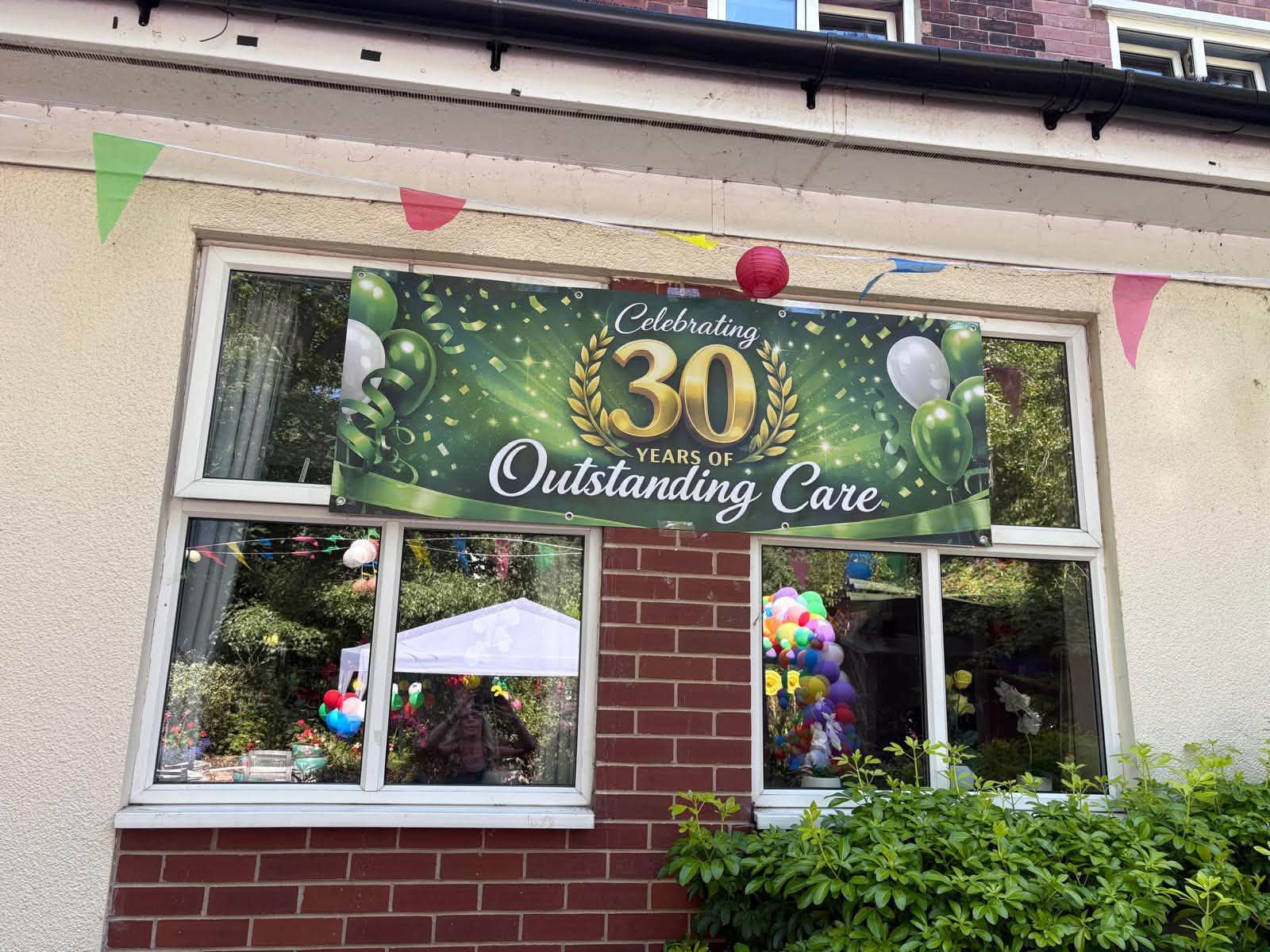 Twelve Trees Care Home Sheffield decorated with banners celebrating 30 years of care