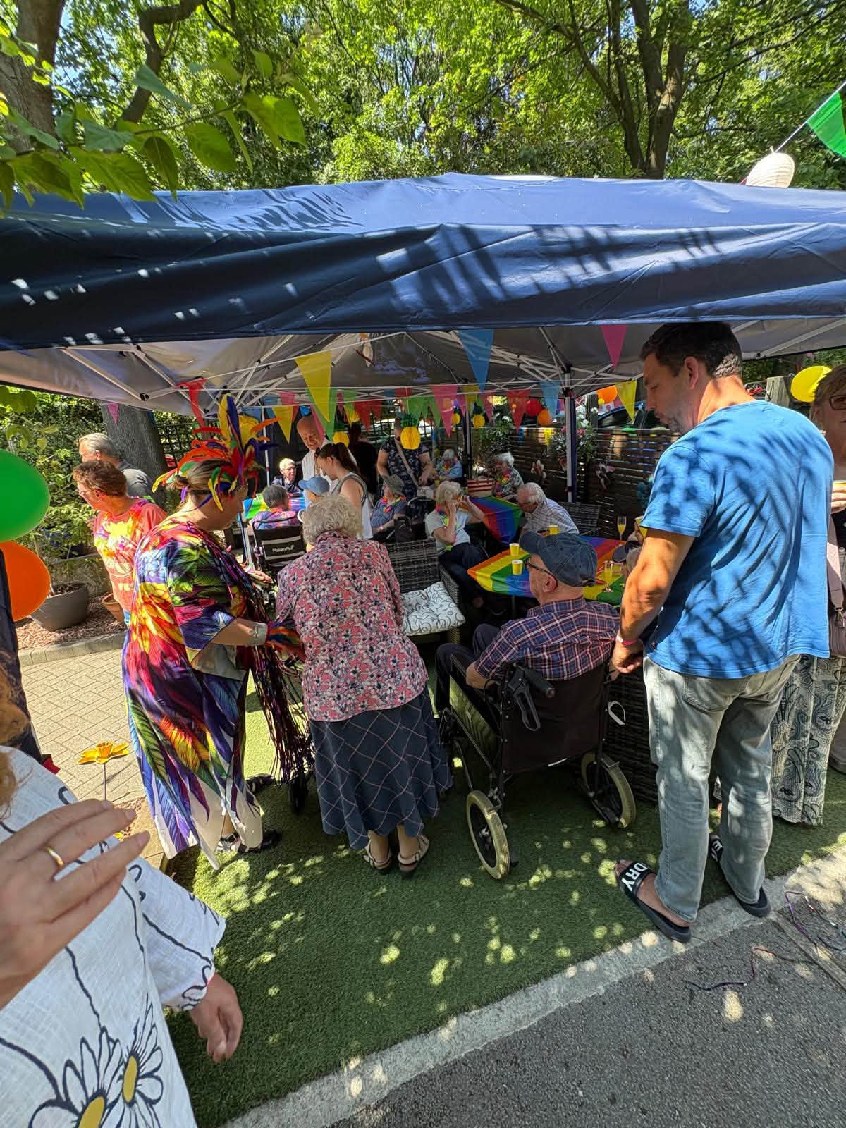 Residents enjoying the 30th anniversary celebrations under the sun canopy at Twelve Trees Care Home