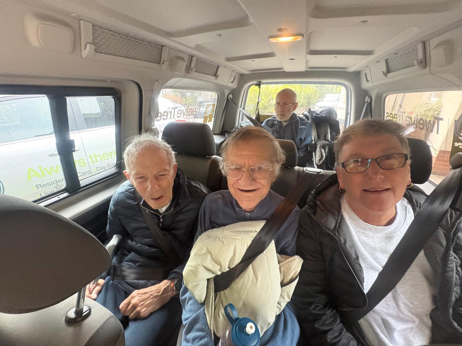 Residents from Twelve Trees Care enjoying a chat on route to a day out